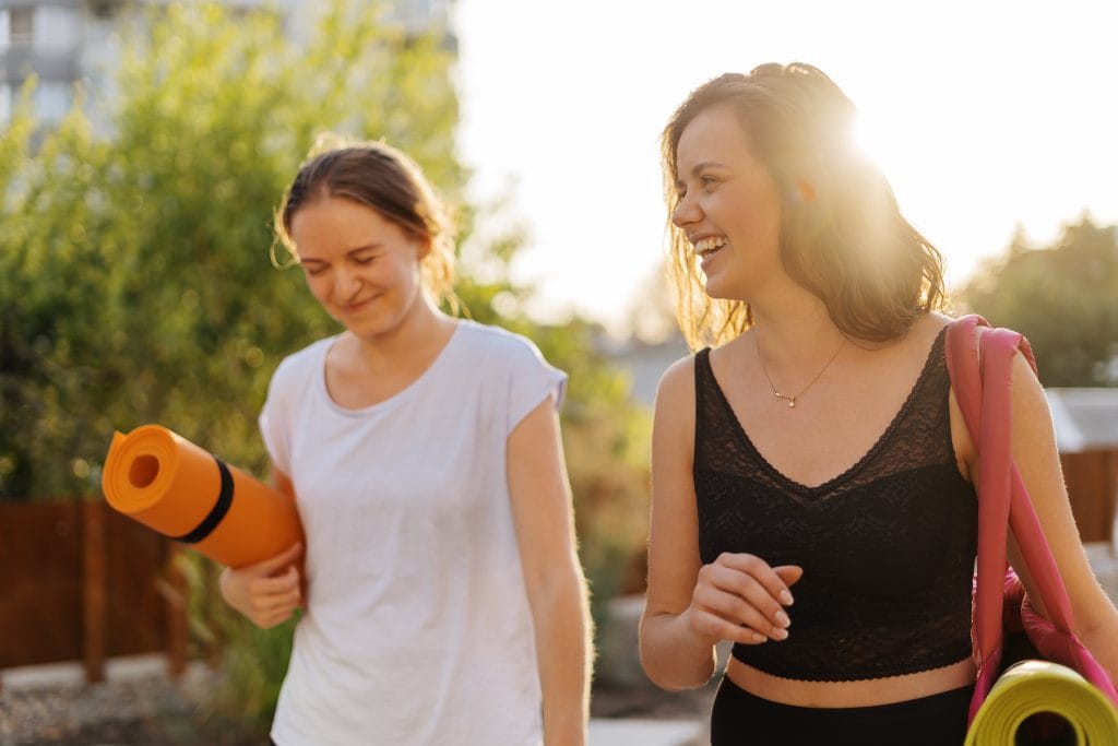 Two young beautiful women in sportswear going to do sports training, gymnastics, yoga reprise sport post partum